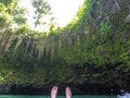 POV of feet floating in To Sua Trench swimming hole, Upolu Island, Western Samoa, South Pacific.