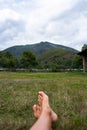 Pov female Bare feet on green grass. Rustic lifestyle. Woman lying on a grass. Relax concept Royalty Free Stock Photo