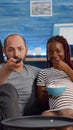 POV of interracial couple with pregnancy watching television Royalty Free Stock Photo