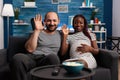 POV of interracial couple on videoconference call in living room Royalty Free Stock Photo