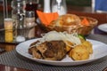 POV Lamb cauldron kabob with fresh vegetables and fried potato on white plate Royalty Free Stock Photo