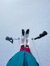 POV: Looking down at your splitboard and poles while enjoying a vacation in Alps