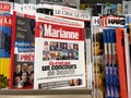 POV male hand buy special edition of Marianne newspaper magazine covering the