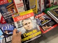 POV male hand buy Valeurs magazine newspaper press headlines with French