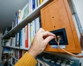 POV male hand connecting cable of Tannoy Mercury V1 bookshelf monitor speakers Royalty Free Stock Photo