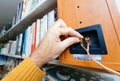 POV male hand connecting cable of Tannoy Mercury V1 bookshelf monitor speakers Royalty Free Stock Photo