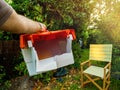 POV male hand holding the grass recipient collector of lawn mower after unboxing Royalty Free Stock Photo