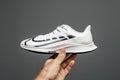 Pov male hand holding new luxury running shoes Nike Zoom react in man's hand