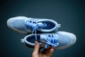 Pov male hand holding new pair of luxury running shoes Nike Zoom react