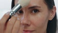 Pov morning girl makeup routine indoors. Portrait woman applying powder alone Royalty Free Stock Photo