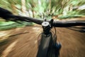 POV, mountain bike and person cycling in nature, park and forest for adventure, speed and motion blur. Closeup