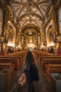 POV photography of a girl entering the beautiful church of Santa Isabel with gold details, located in the City of Tlaxcala, Mexico