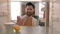 POV point of view from inside refrigerator hungry Caucasian man at kitchen open empty fridge with half of lemon and jam Royalty Free Stock Photo