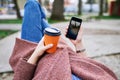 POV pretty woman lying on the bench in spring park and holding m Royalty Free Stock Photo