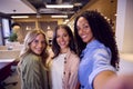 POV Selfie Portrait Of Multi-Cultural Female Business Team Standing In Modern Open Plan Office Royalty Free Stock Photo