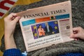 POV of senior hands holding latest Financial Times newspaper featuring Eu