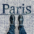 a pov shot looking down on a persons feet standing on a mosaic tiled floor with the word Paris
