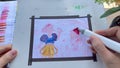 POV view of artist starting to apply blocks of colours using alcohol markers. Snowwhite and dwarf hand drawn by a