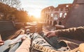 Pov view of couple enjoying sunset in front of colosseum - Young people having fun traveling europe - Trip, love and relationship