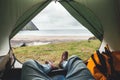 POV view of hipster tourist inside tent on front of mountains and sea