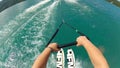 POV view of waterskiing. Water ski action camera, hands hold rope.