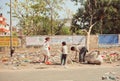 Poverty in action, family of poor children and father looking for plastic rubbish in trash heap to earn penny