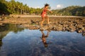 Poverty child plays on the beach