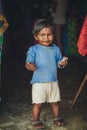 Poverty, photo of a little poor Indian girl in old ragged clothes, standing full-length. Chocolate baby