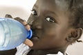 Poverty Symbol: African Black Girl Drinking Heathy Fresh Water. Royalty Free Stock Photo