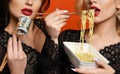 Poverty and wealth concept. Rich and poor girls friends hold stack of money dollars cash Chinese chopsticks eating cheap noodles