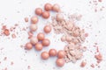 Powder in the balls with a radiant effect on the background of the set for blush. Make-up cosmetics, Royalty Free Stock Photo