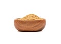 Powder of ground ginger root in a wooden bowl over white background. Royalty Free Stock Photo