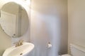 Powder room interior with ambient lightning and wall mounted tissue holder