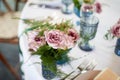 Powder roses in small blue vases.Wedding decor or romantic date design. Floristics.