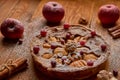 Powdered apple pie with fresh cranberries and walnuts decorated with apples, cinnamon. Just baked powdered apple pie ready to eat Royalty Free Stock Photo