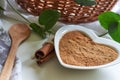 Powdered cinnamon in heart shaped bowl