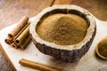 Powdered cinnamon and stick, in a rustic wooden bowl, exotic cinnamon from Brazil