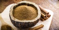 Powdered cinnamon and stick, in a rustic wooden bowl, exotic cinnamon from Brazil