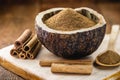 Powdered cinnamon and stick, in a rustic wooden bowl, exotic cinnamon from Brazil