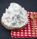 Powdered cream Powder Cream whipped cream in plate on wooden floor. Cooking buttery cream on kitchen