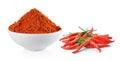 Powdered dried red pepper and red chili peppers in a white bowl Royalty Free Stock Photo