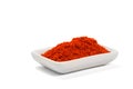 Paprika ground in a white bowl on white background.