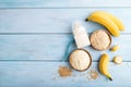 Powdered milk and oatmeal, banana baby food mix, on blue wooden, top view, copy space Royalty Free Stock Photo