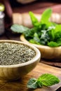 powdered mint leaves, preparation for mint tea in recycled wooden bowl