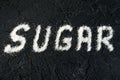 Powdered white sugar on a black background. Sugar Inscription on a dark background