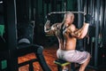 Power athletic guy bodybuilder, execute exercise with gym apparatus, on broadest muscle of back Royalty Free Stock Photo