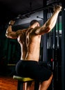 Power athletic guy bodybuilder, execute exercise with gym apparatus, on broadest muscle of back Royalty Free Stock Photo