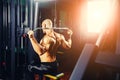 Power athletic guy bodybuilder, execute exercise with gym apparatus, on broadest muscle of back Royalty Free Stock Photo