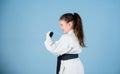 Power and balance. sport success in single combat. small girl in martial arts uniform. practicing Kung Fu. happy