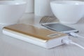 Power bank charges cell phone on the kitchen table